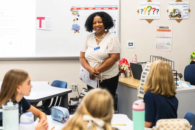 Teacher smiling as she leads a small class