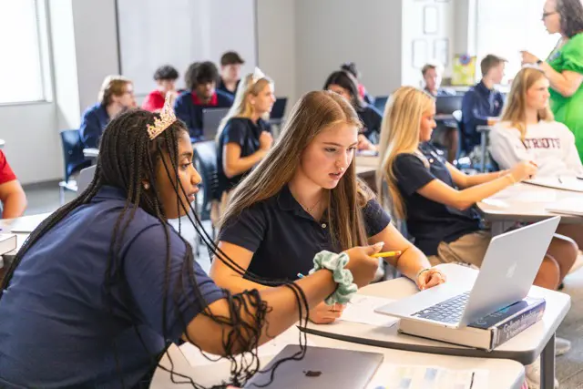 Upper School students working together at a classroom table