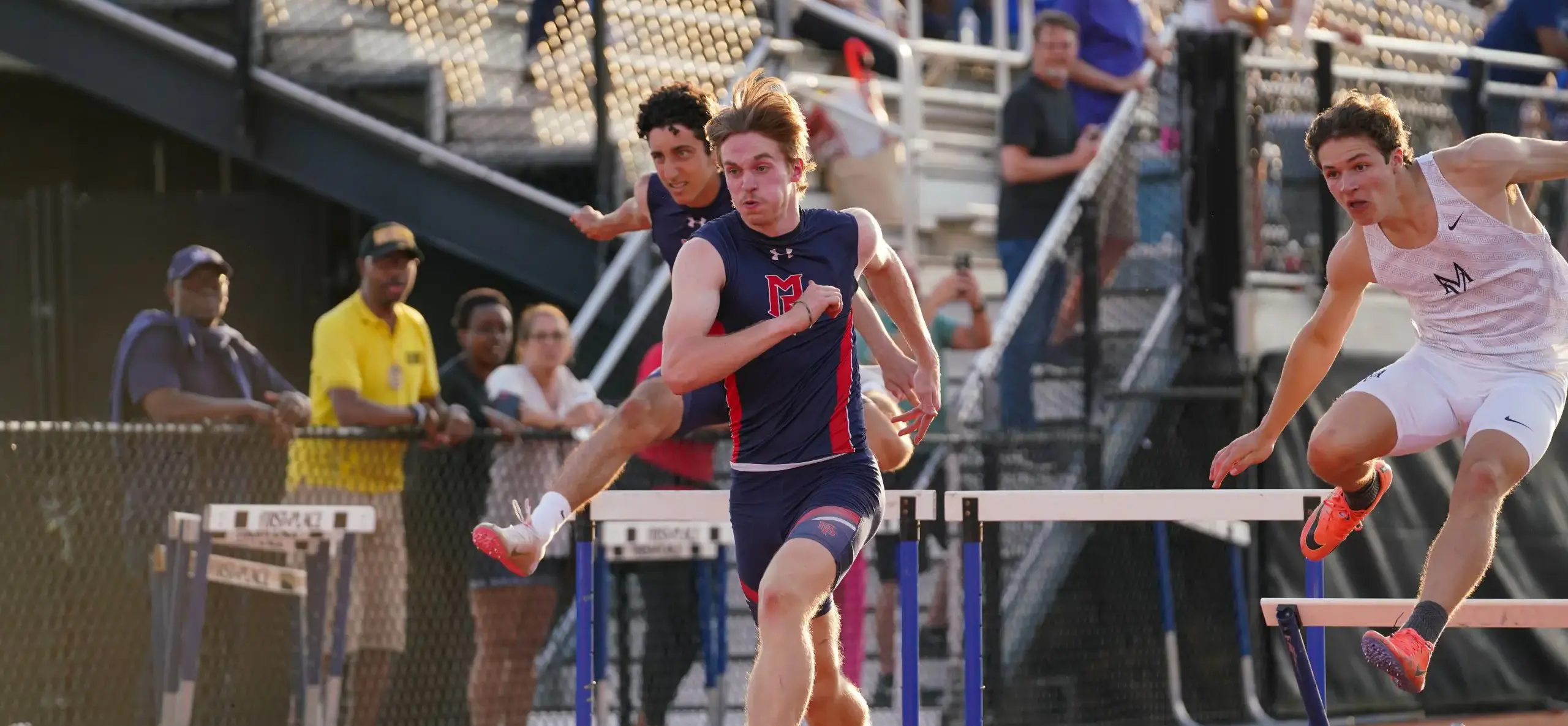 Student athlete jumping a hurdle