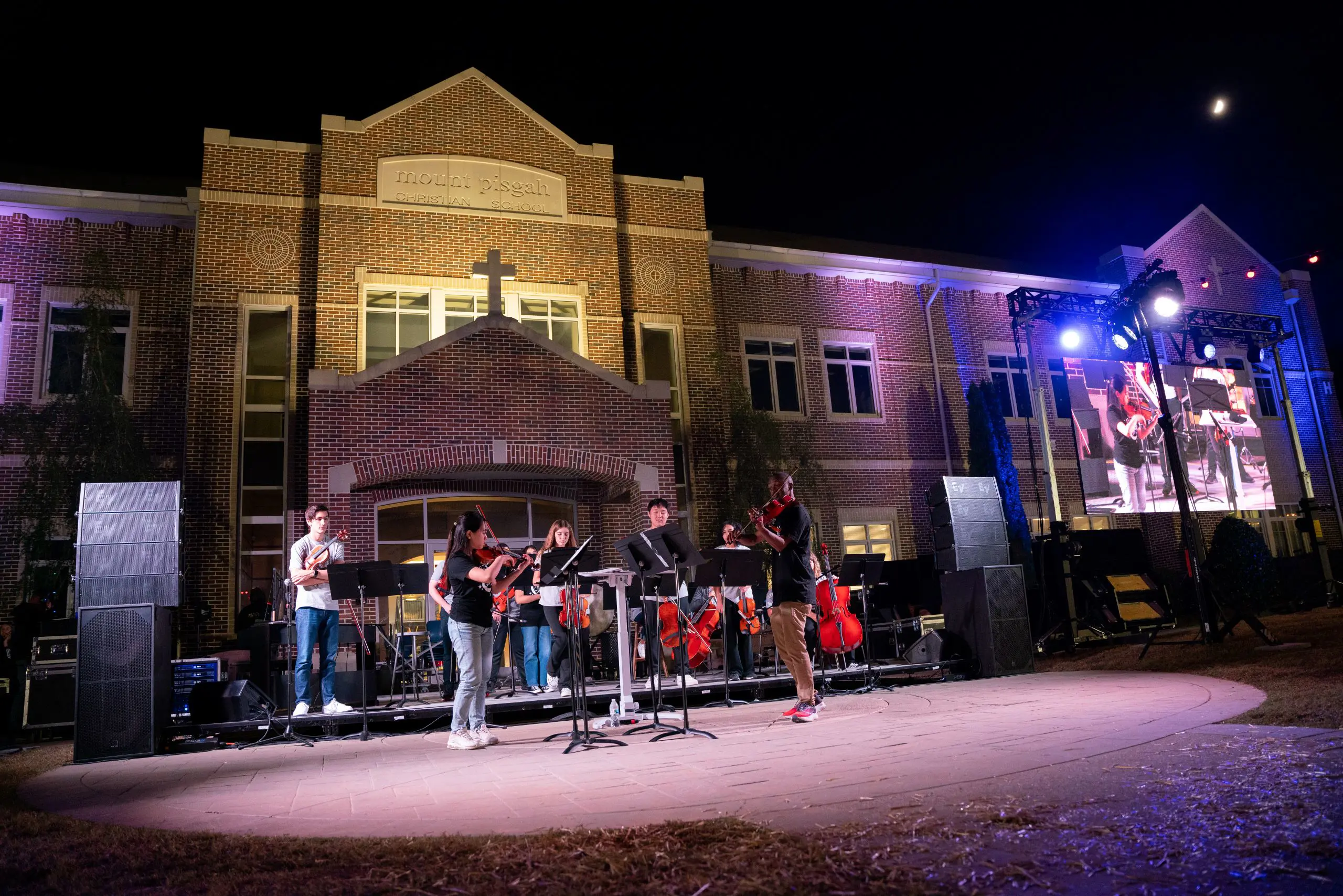 Students performing outside with instruments