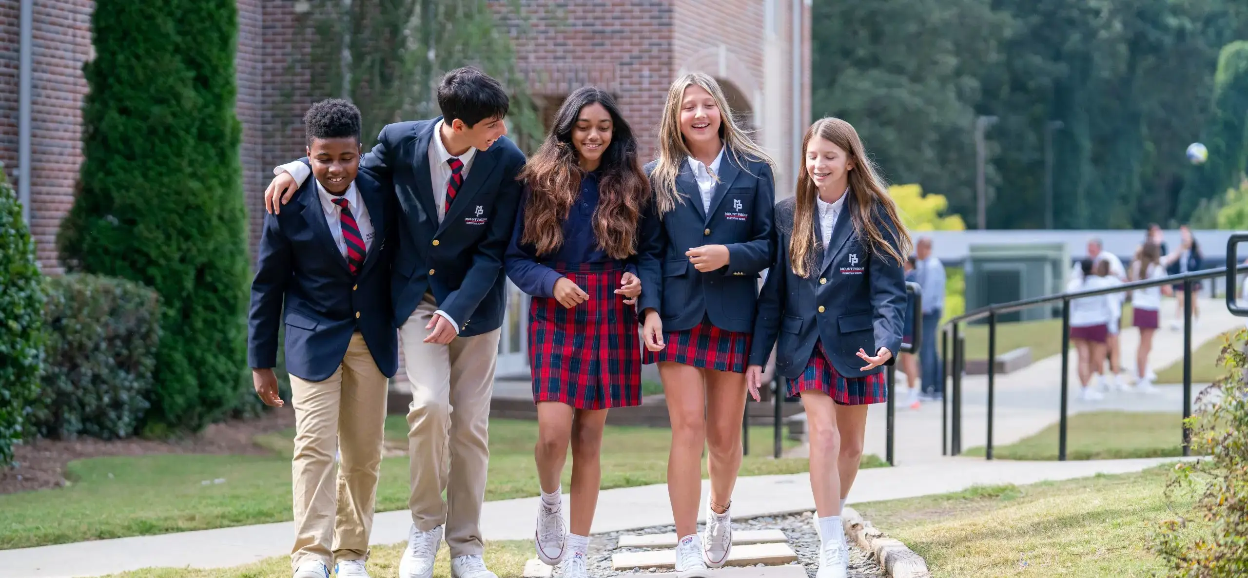 Group of students walking outside school building