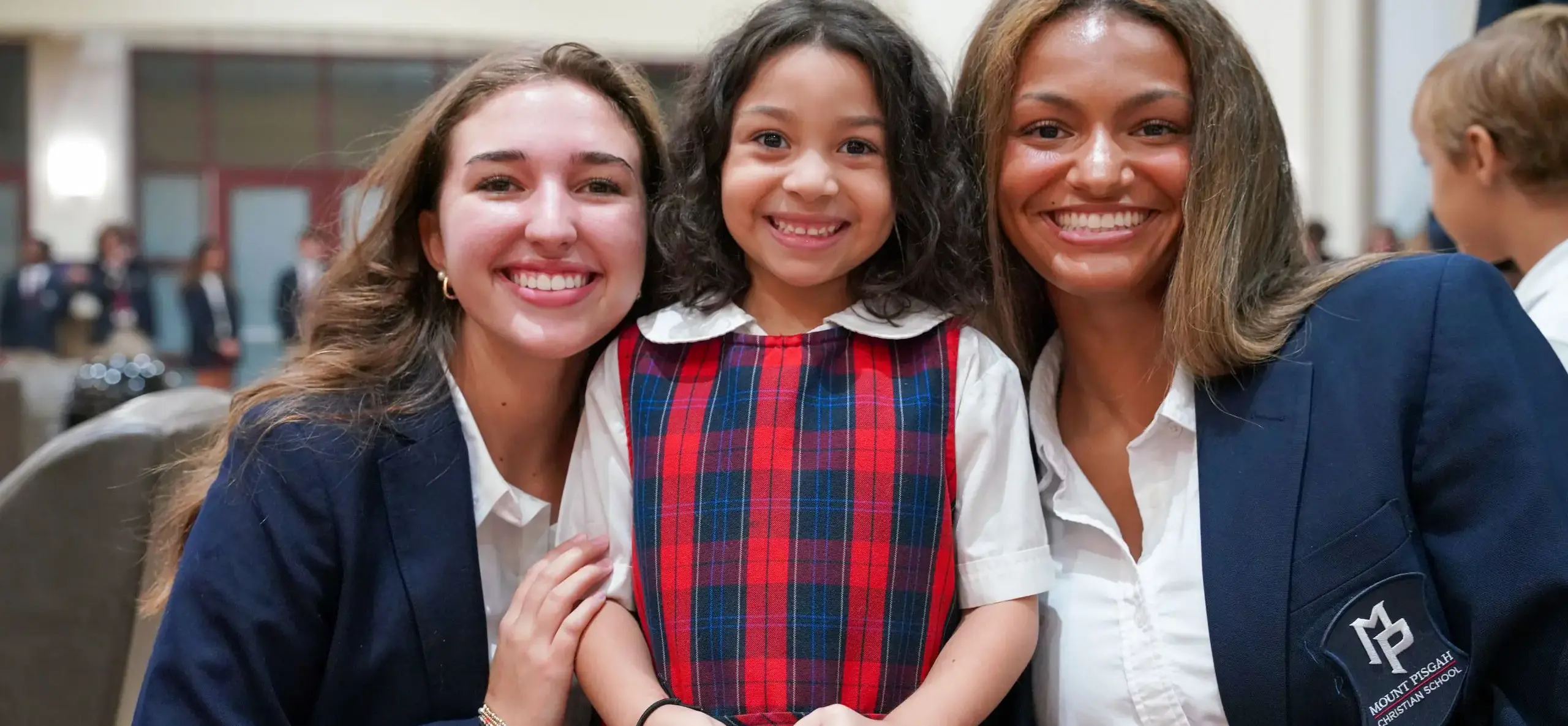 Three students smiling