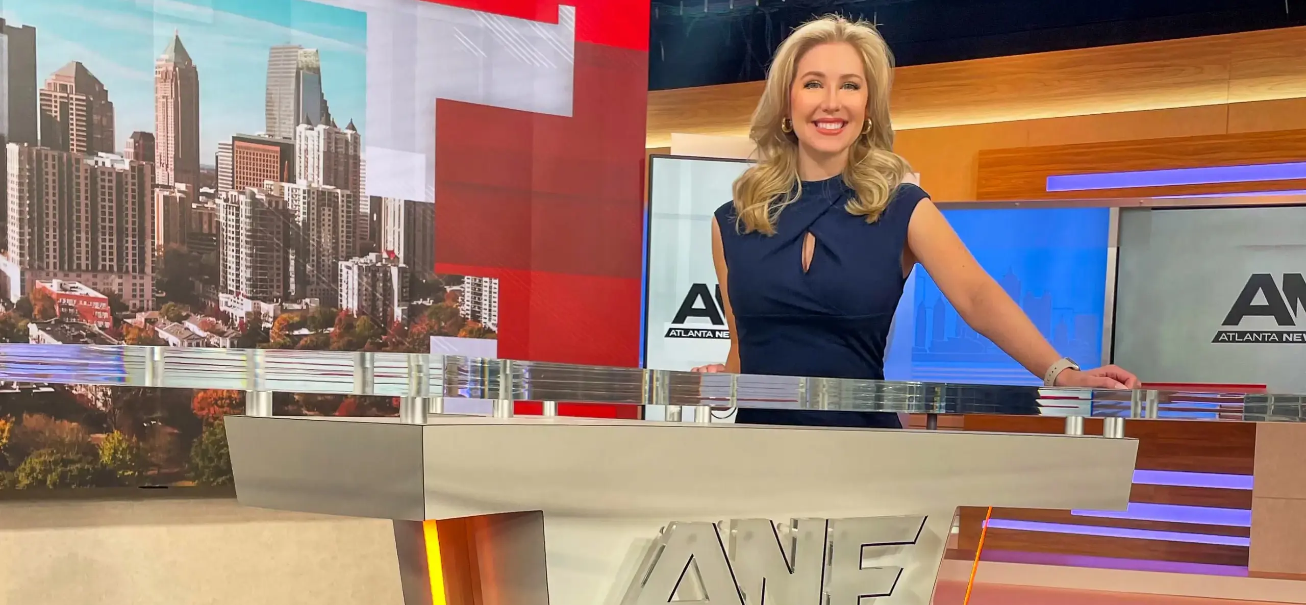 News anchor Karli Barnett in front of a news desk