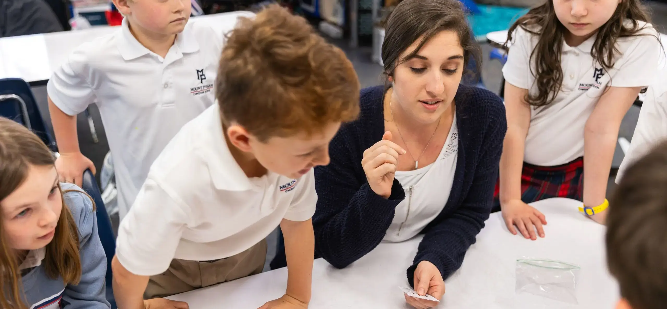 Teacher showing a demonstration to children