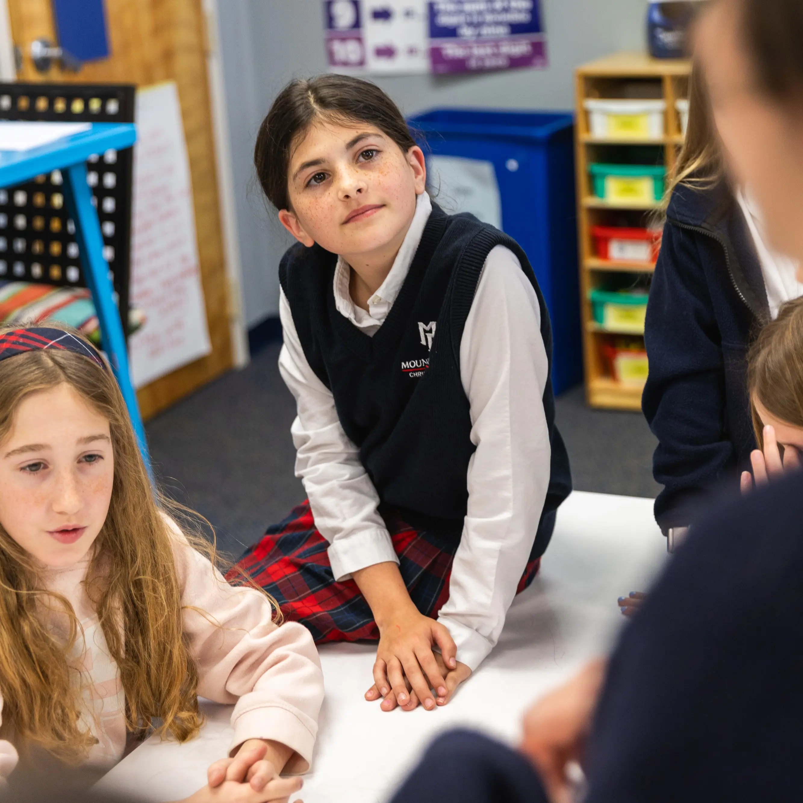 Lower School girl listens to her teacher in class