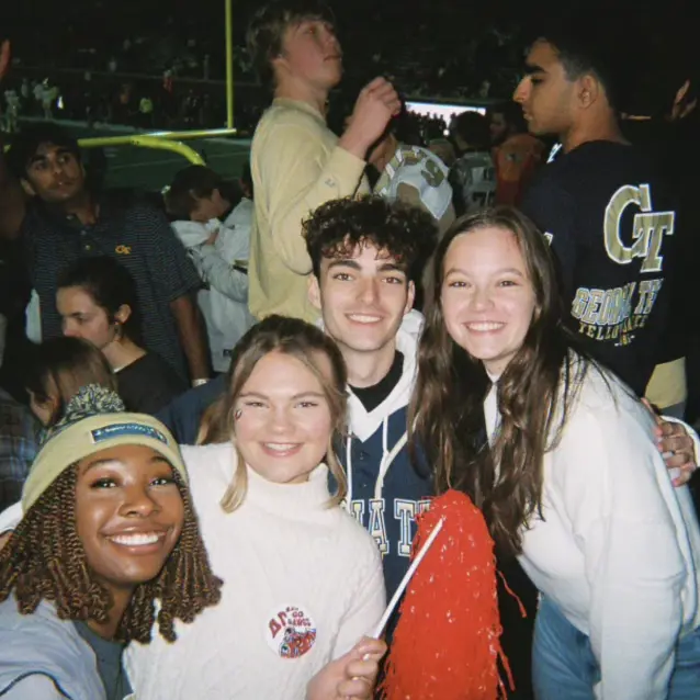 Group of students smiling on bleachers