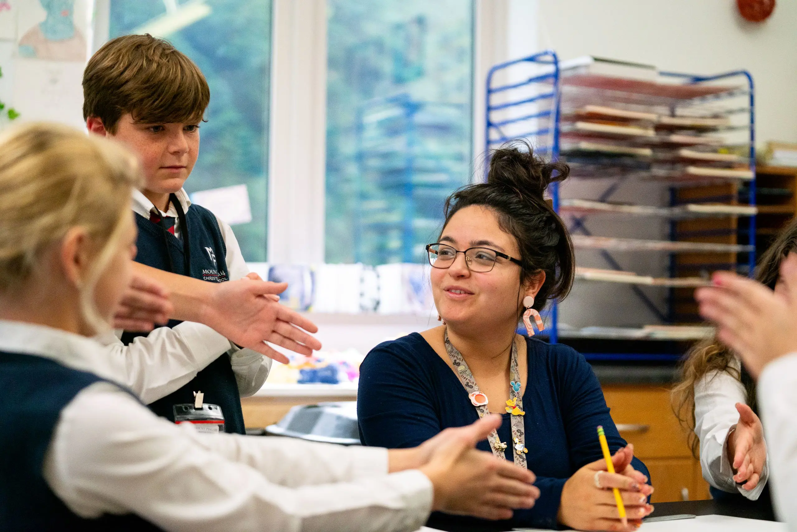 Teacher instructing students, smiling