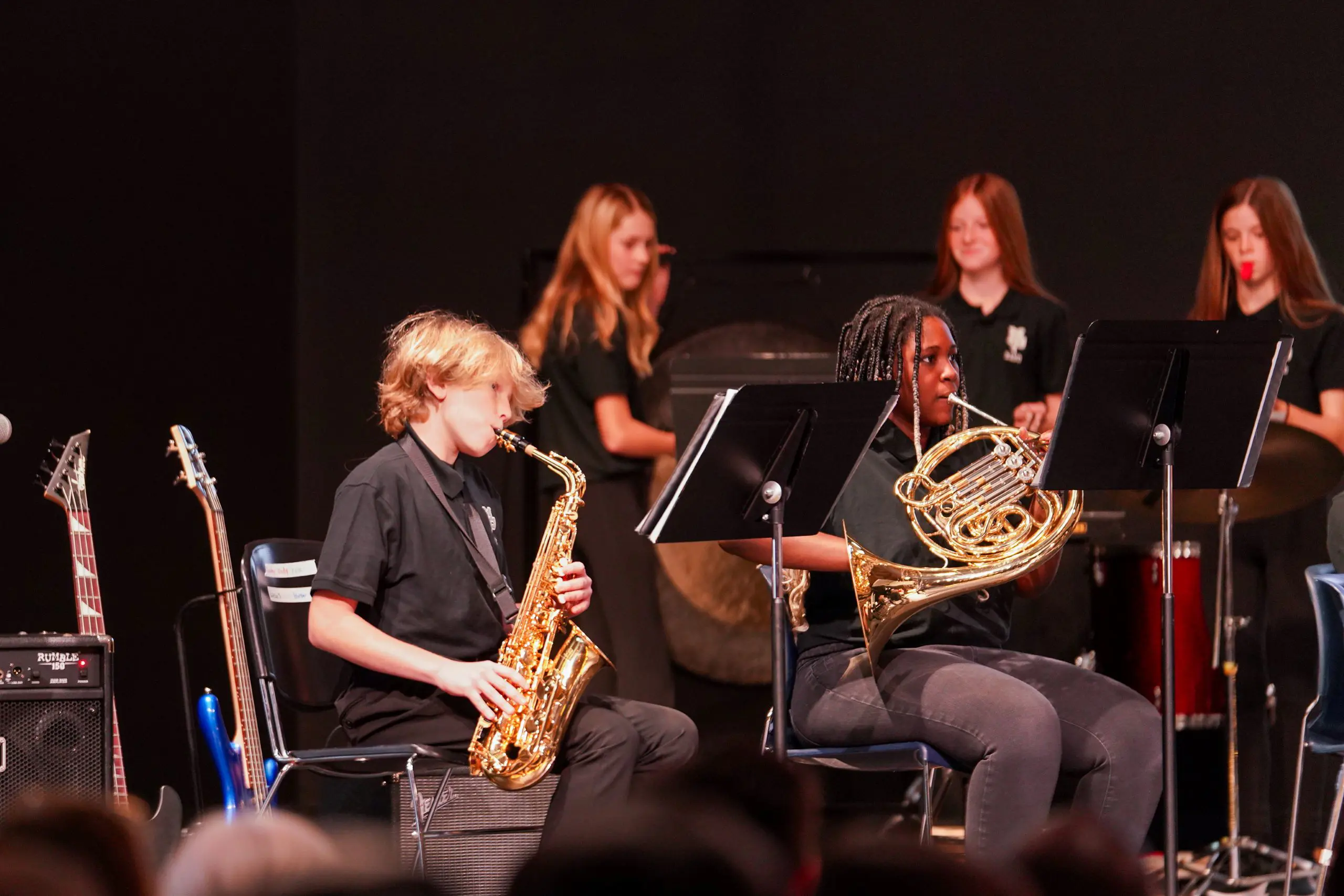 Students playing instruments onstage