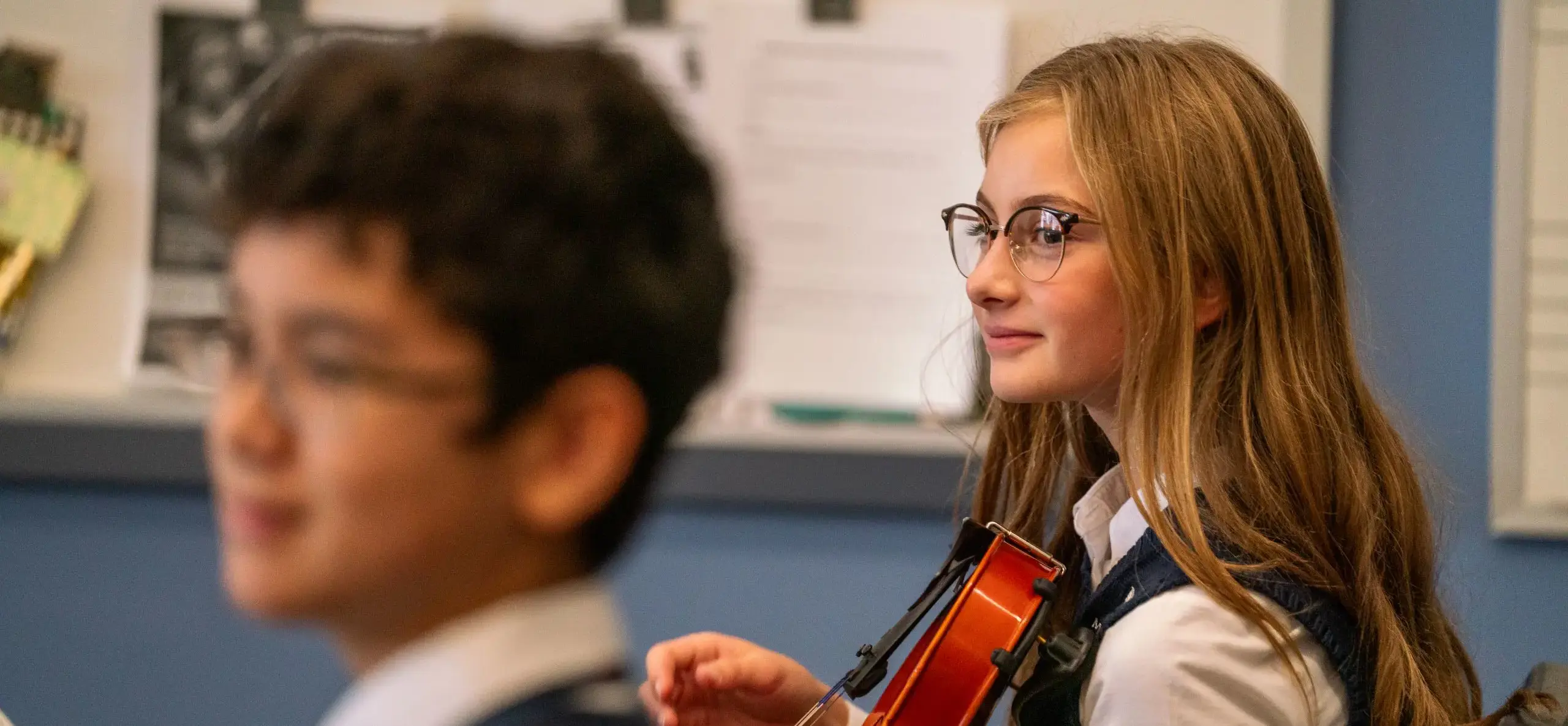 Two students holding violins