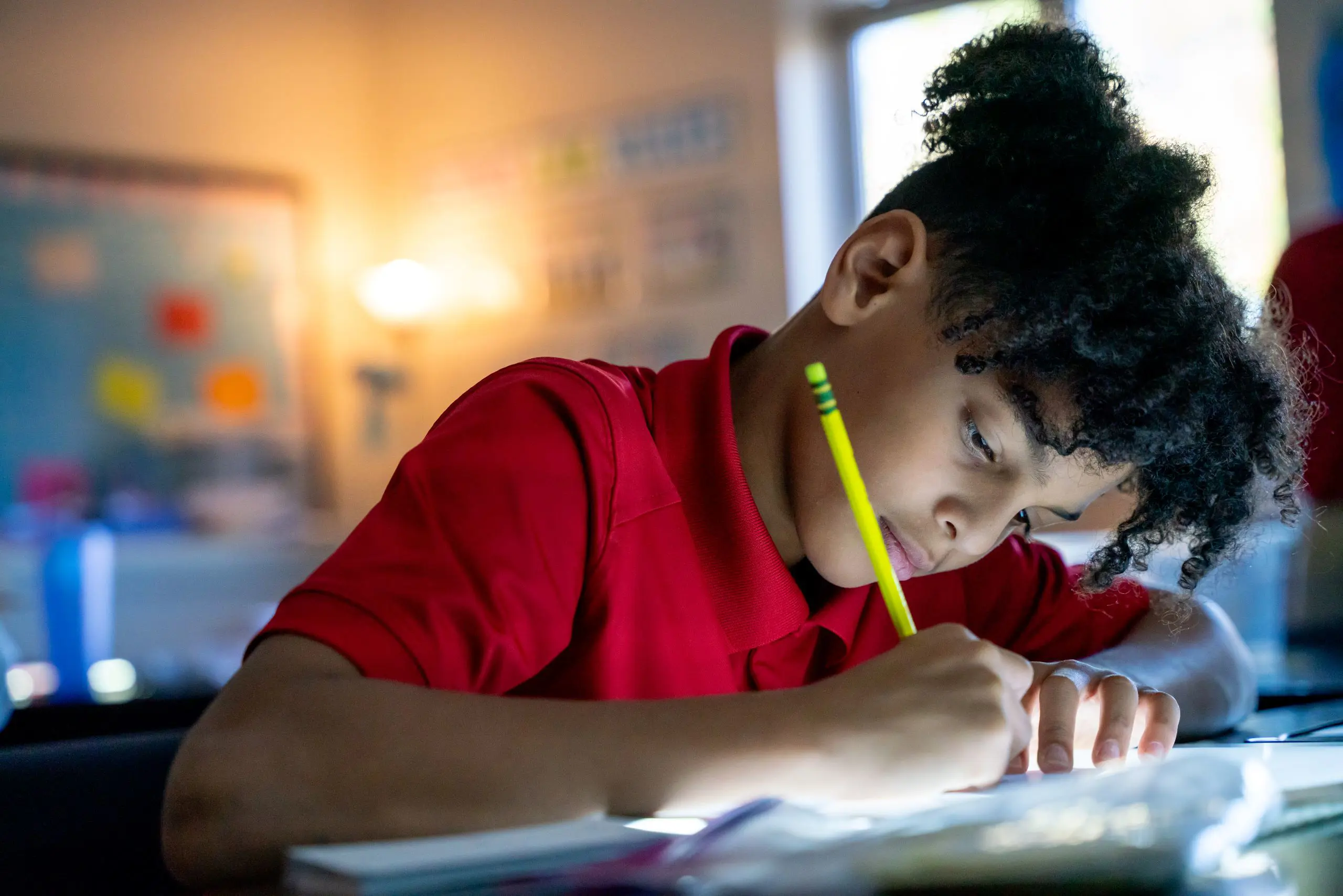 Student writing with a pen