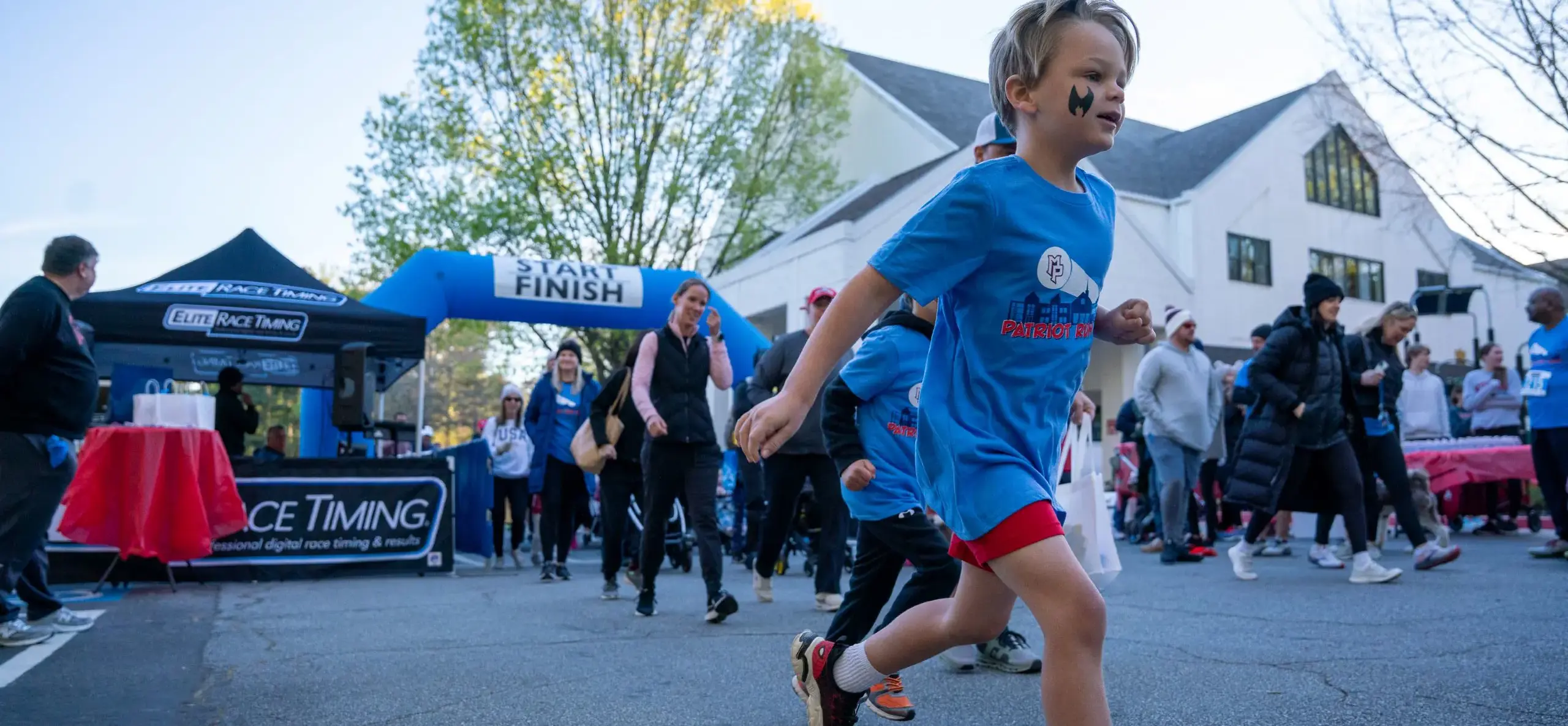 Children running from a blow-up starting line