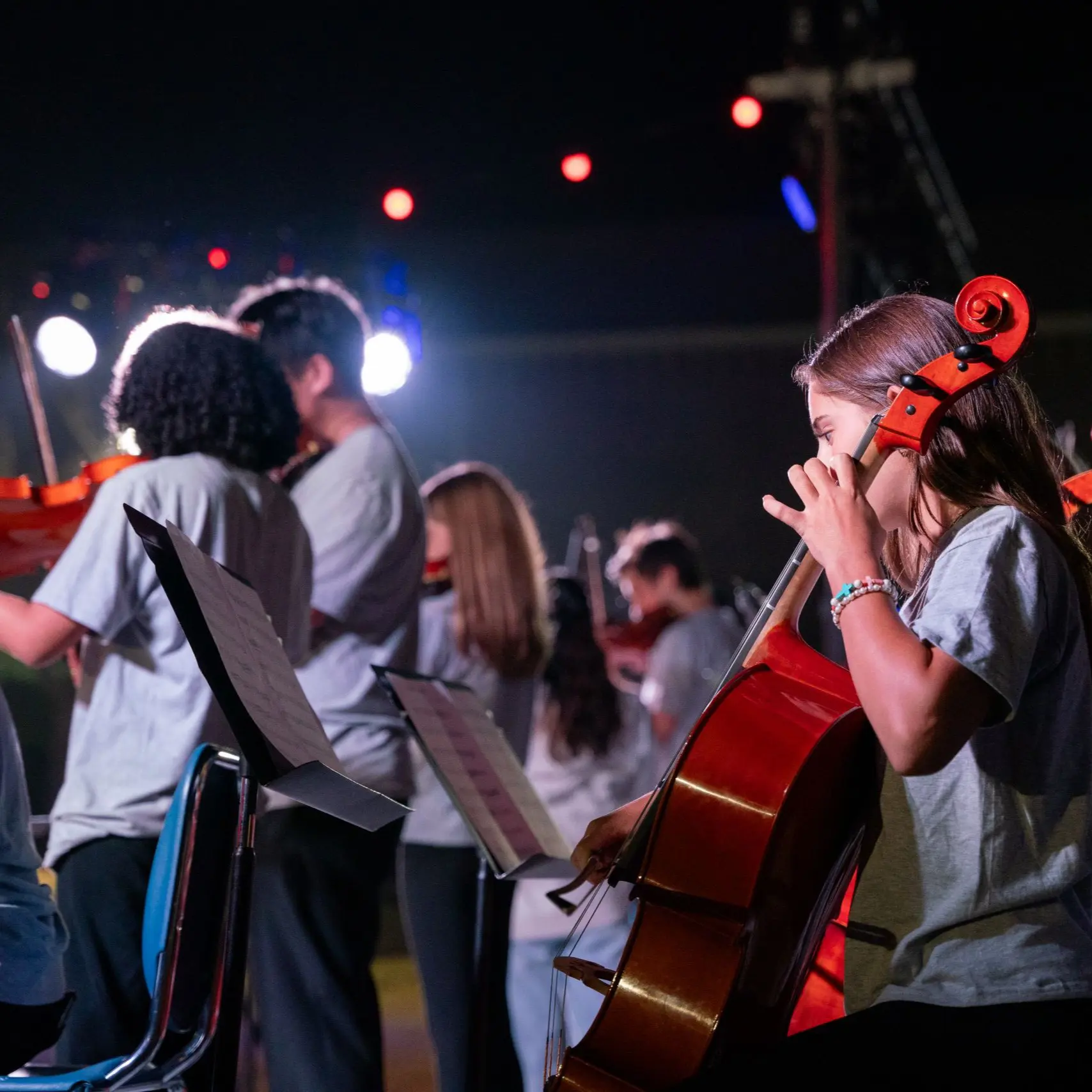 Students performing onstage with instruments