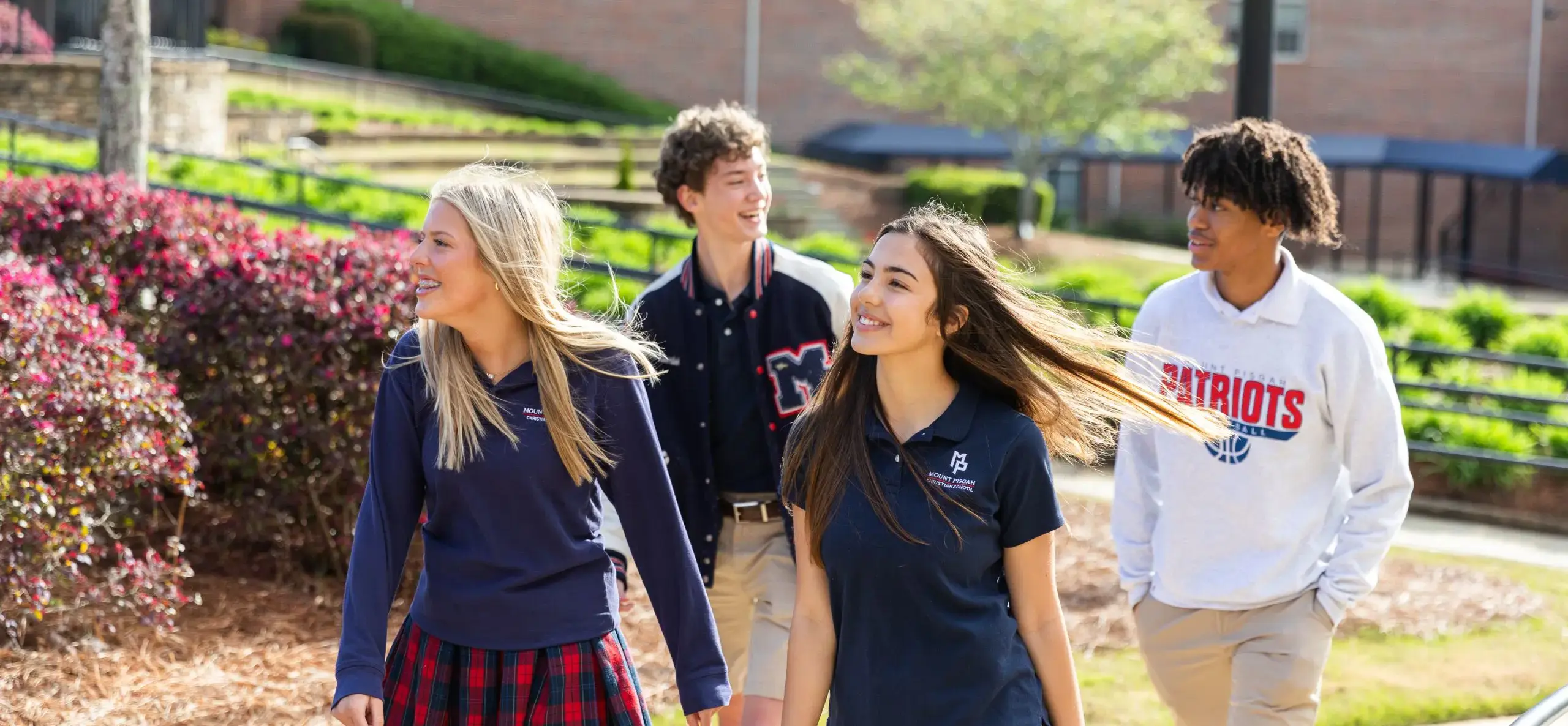 Four students walking outside