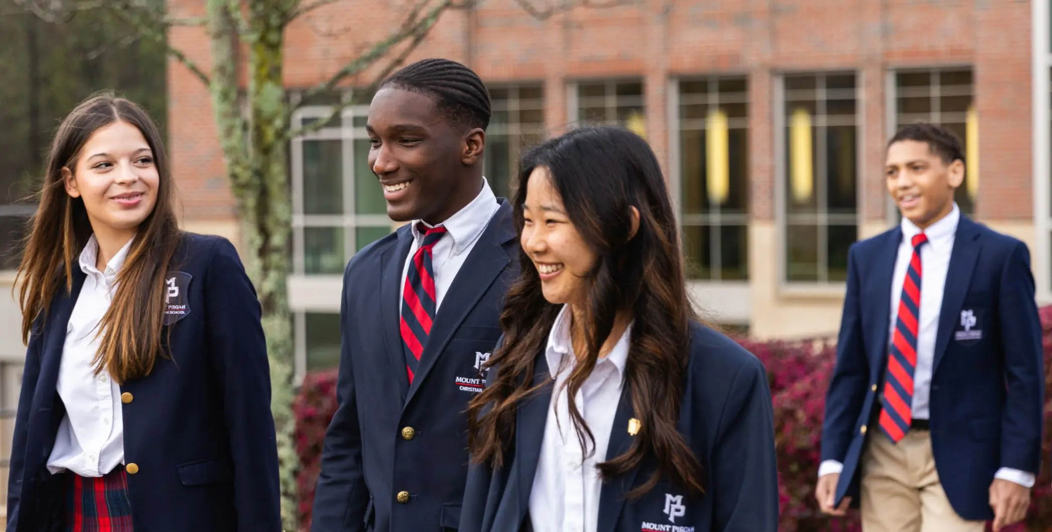 Four students walking outside